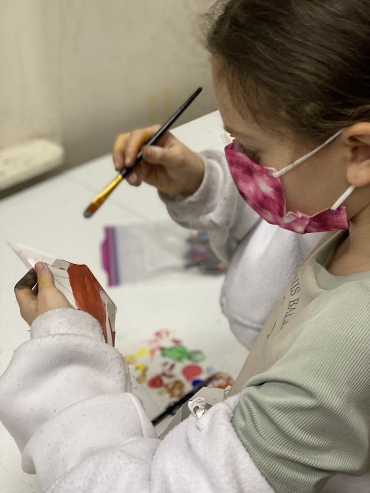 Student working on creative paper art project during kids art classes in NYC